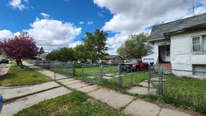 View of yard with a gate and fence