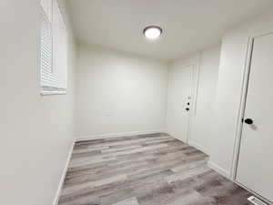 Spare room with visible vents, light wood-style flooring, and baseboards