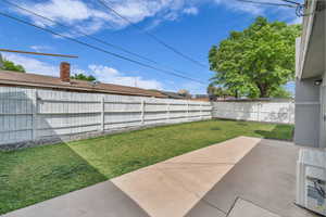 View of yard featuring a fenced backyard and a patio area