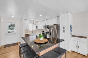 Dining room featuring light wood finished floors and recessed lighting