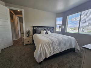 Carpeted bedroom featuring a textured ceiling
