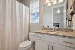 Bathroom with toilet, ensuite bathroom, and vanity