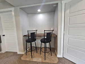 Interior space featuring a textured ceiling, baseboards, recessed lighting, and carpet