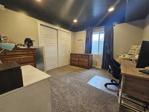 Carpeted office space featuring recessed lighting