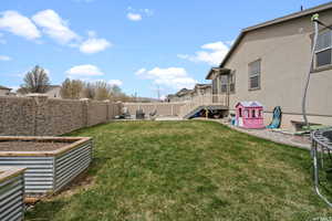 View of yard with a patio, a fenced backyard, stairs, and a vegetable garden