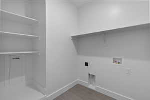 Clothes washing area with hookup for a washing machine, hookup for an electric dryer, laundry area, and baseboards