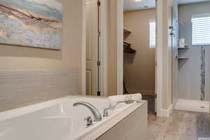 Full bathroom with tiled shower and a bath