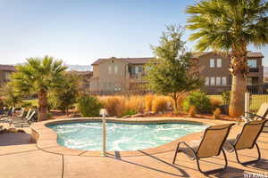 View of swimming pool featuring a patio and fence