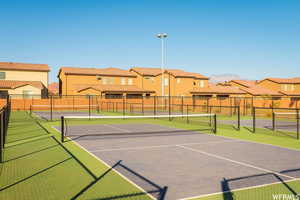 View of sport court with fence and a residential view