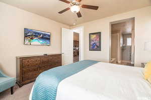Carpeted bedroom featuring a ceiling fan and baseboards