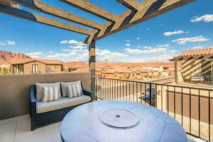Balcony featuring outdoor dining space and a residential view