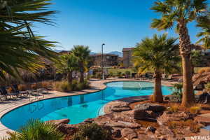 Pool with a patio and fence