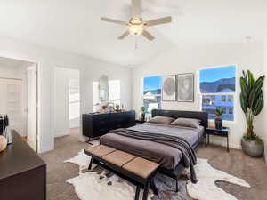Bedroom featuring a ceiling fan, visible vents, light carpet, baseboards, and lofted ceiling