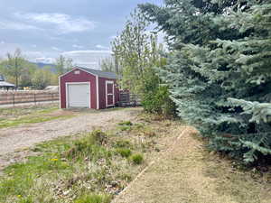 Detached garage with a storage unit and fence