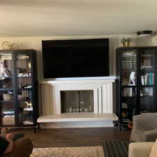 Living room with a fireplace and wood finished floors