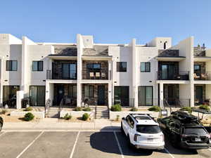 View of property featuring uncovered parking