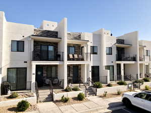 View of property featuring uncovered parking