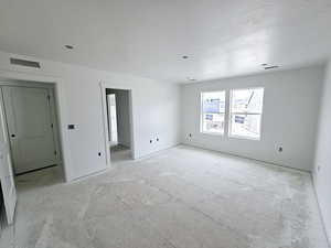 Empty room featuring baseboards and a textured ceiling