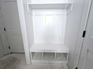 Mudroom with baseboards and unfinished concrete floors