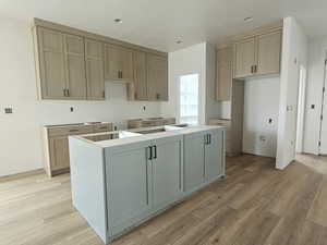 Kitchen with a center island, recessed lighting, and light wood-type flooring