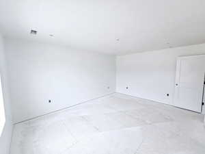 Spare room featuring baseboards
