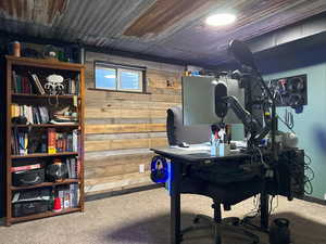 Office with carpet and wooden walls