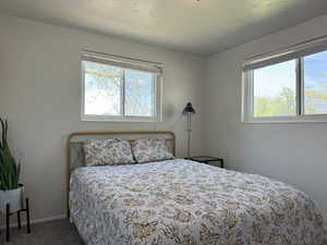 Carpeted bedroom featuring baseboards