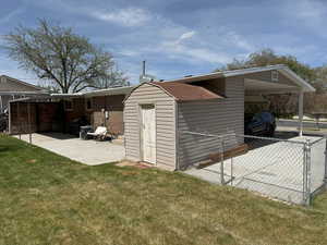 View of outbuilding with fence
