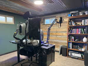 Carpeted office with wood walls