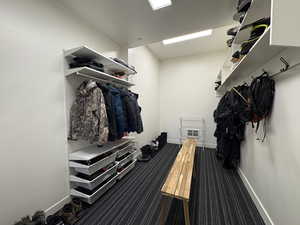 Mudroom with baseboards and carpet