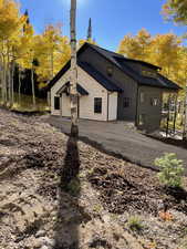 Exterior space with dirt driveway and board and batten siding