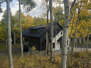 View of property exterior featuring a shingled roof