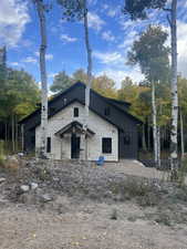 View of side of property with board and batten siding and stone siding