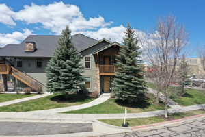 View of front facade featuring a balcony and a front yard