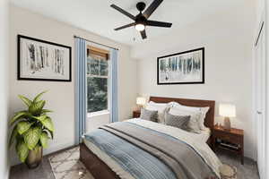 VIRTUALLY STAGED - Bedroom featuring a ceiling fan, light colored carpet, and baseboards