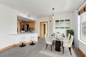 Dining area featuring baseboards, light carpet, recessed lighting, and visible vents