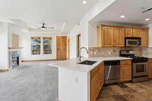 Kitchen featuring quartz countertops, counter seating, appliances with stainless steel finishes, and open floor plan