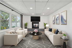 Living room featuring a brick fireplace and recessed lighting