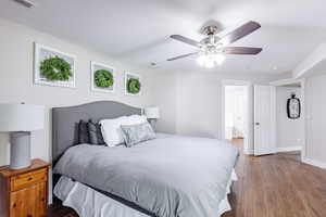 Owner's suite with large slider to balcony, large walk-in closet, and solid dresser with TV.