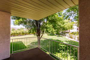 View of corner patio to large grassy area below.