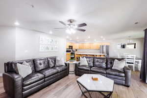 Family room with two leather sofas, coffee table, and full kitchen.