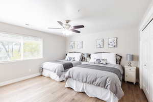 Bedroom featuring Hunter ceiling fan, with partial walk-in closet.