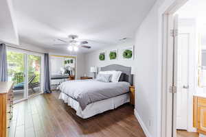 Owner's suite with large slider to balcony, large walk-in closet, and solid wood dresser.