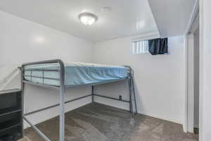 Bedroom featuring carpet flooring and a textured ceiling