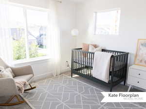 Bedroom with carpet flooring, baseboards, and a crib