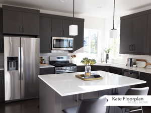 Kitchen with appliances with stainless steel finishes, a kitchen breakfast bar, and backsplash