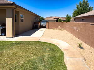 View of yard with central AC and a patio
