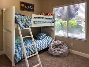 Carpeted bedroom featuring baseboards