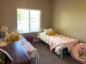 Bedroom with carpet floors and baseboards