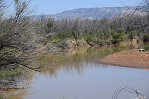 View of water feature with a mountain view